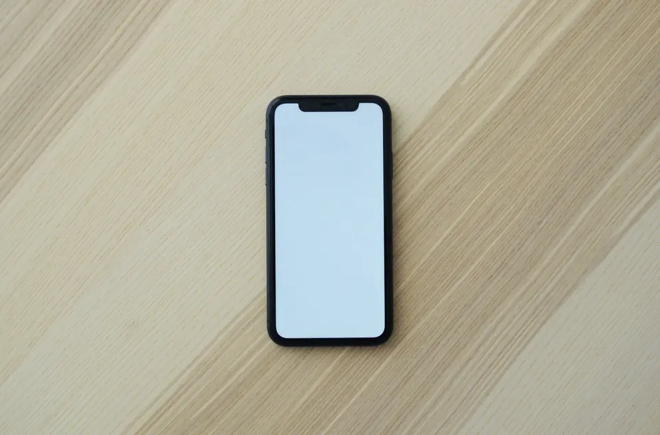 Smartphone resting on a wooden table